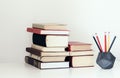 Stack of books and pencils in holder, education concept background, many books piles with copy space for text