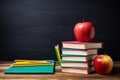 stack of books and pencils on school table against blackboard with an apple on top. Back to school concept, learning Royalty Free Stock Photo