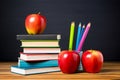 stack of books and pencils on school table against blackboard with an apple on top. Back to school concept, learning Royalty Free Stock Photo