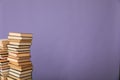 stack of books on a purple background science education culture training