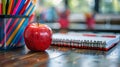 Stack of books, red apple and colorful pencils in case Royalty Free Stock Photo