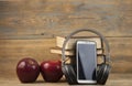 Stack of books with red apple and digital tablet, headphone  on the wood table with blackboard Royalty Free Stock Photo