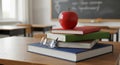Stack of Books with Red Apple and Glasses on a Classroom Desk Royalty Free Stock Photo