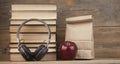 Stack of books with red apple and headphone  on the wood table with copyspace Royalty Free Stock Photo