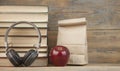 Stack of books with red apple and headphone  on the wood table with copyspace Royalty Free Stock Photo