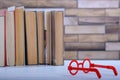 Stack with books and red glasses on the table, education concept, background Royalty Free Stock Photo