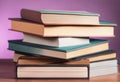 a stack of books sitting on top of a wooden table Royalty Free Stock Photo