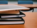 Stack of books and tablet on the table. Royalty Free Stock Photo