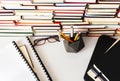 Stack of books, textbook, laptop, glasses in office business background for education learning concept