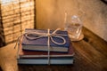 Stack of Books tied with a string with a glass of water in background