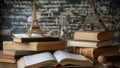 Stack of books on top of each other in front of a blackboard Royalty Free Stock Photo