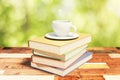 Stack of books on a vintage wooden table with cup of coffee in n Royalty Free Stock Photo