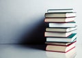 Stack of books on white reflective surface Royalty Free Stock Photo