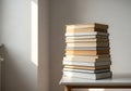 Stack of Books on a White Table in Bright Room - Education, Reading, Learning Royalty Free Stock Photo