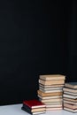 stack of books on a white table in the library on a black background Royalty Free Stock Photo