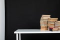 stack of books on a white table in the library on a black background Royalty Free Stock Photo