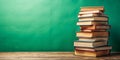 Stack of books on wooden table against green background. AI generated Royalty Free Stock Photo