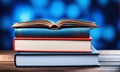 stack of books on the wooden table on blue background, copy space Royalty Free Stock Photo