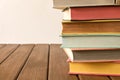 Stack of books on a wooden table. The concept of education and knowledge from books. Close up. With empty space for text.