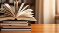 Stack of books on wooden table in library setting Royalty Free Stock Photo