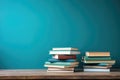 Stack of books on wooden table over blue wall background. Back to school concept, Books on wooden table with teal background for Royalty Free Stock Photo