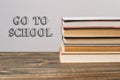 A stack of books with the word Go to School written on top Royalty Free Stock Photo