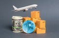 A stack of boxes, airplane a bundle of dollars and a blue planet earth globe. World trade and commodity exchange. commerce traffic Royalty Free Stock Photo