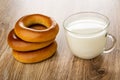 Stack of bread rings baranka, cup with milk on table Royalty Free Stock Photo