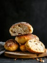A stack of bread rolls sitting on top of a wooden cutting board Royalty Free Stock Photo