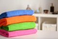 Stack of bright color towels on table