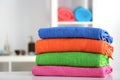 Stack of bright color towels on table