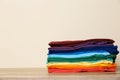 Stack of bright folded clothes on table Royalty Free Stock Photo