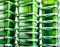 A stack of bright green plastic storage containers with translucent lids Royalty Free Stock Photo