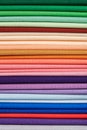Stack of bright self-colored cotton fabrics as a background image Royalty Free Stock Photo