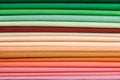 Stack of bright self-colored cotton fabrics as a background image Royalty Free Stock Photo