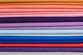 Stack of bright self-colored cotton fabrics as a background image Royalty Free Stock Photo