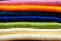 Stack of brightly coloured alpaca blankets