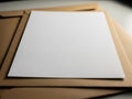 Stack of brown cardboard folders with a white sheet of paper on top Royalty Free Stock Photo