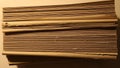 A stack of brown cardboard sheets is neatly piled photographed from the side Royalty Free Stock Photo
