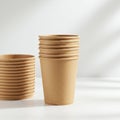 A stack of brown, disposable paper cups arranged on a white surface. The cups are Royalty Free Stock Photo