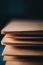 A stack of brown envelopes with a dark background. The envelopes are piled on top of each other, creating a sense of depth and Royalty Free Stock Photo