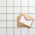 Stack of brown envelopes with white inserts is arranged on a Royalty Free Stock Photo
