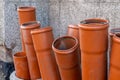 Stack of brown pvc pipes. Close up of orange plastic pipes on construction. Industrial background. Royalty Free Stock Photo