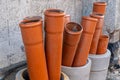 Stack of brown pvc pipes. Close up of orange plastic pipes on construction. Industrial background. Royalty Free Stock Photo