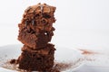 Stack of brownies on white wooden background. Chocolate cake close up. Royalty Free Stock Photo