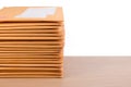 Stack of bubble wrap padded mailing envelopes and pen on white b Royalty Free Stock Photo