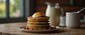 A stack of buckwheat flour pancakes served with a side of crispy bacon and eggs sunny side up. Royalty Free Stock Photo