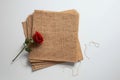 Stack of burlap sheets with a red rose on top Royalty Free Stock Photo