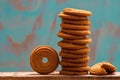 Stack of butter cookies/biscuits on wooden board with teal green rustic background Royalty Free Stock Photo