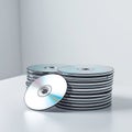 Stack of C Ds with One Disc in Front on White Surface pile Royalty Free Stock Photo